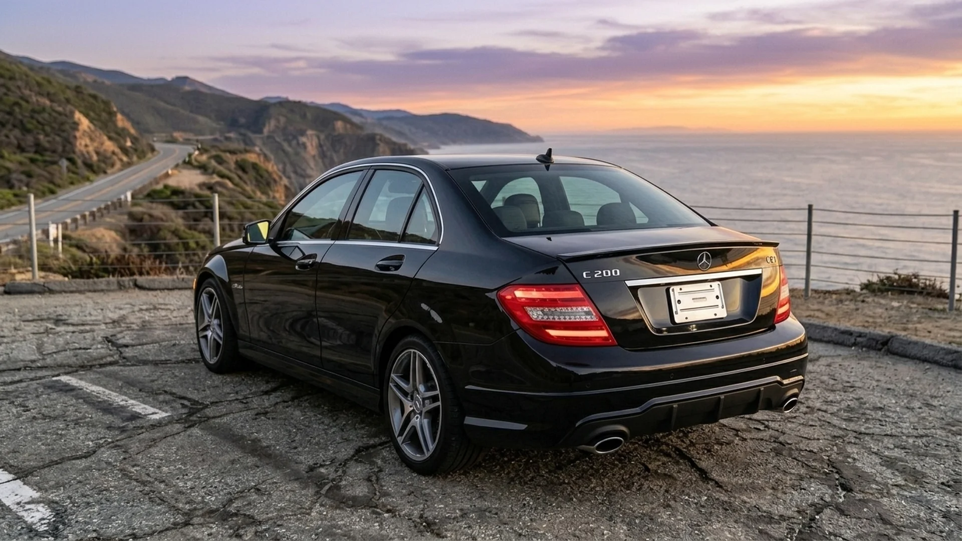 Mercedes-Benz W204 C200 CGI rear bumper view showing dual exhaust and AMG diffuser at sunset